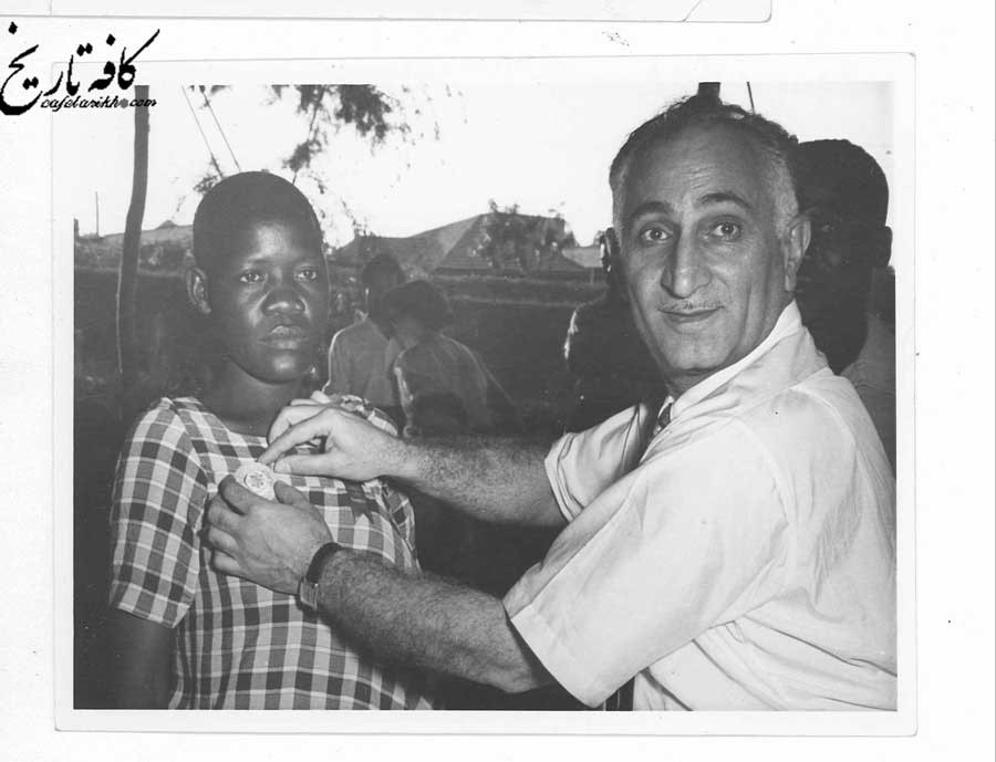 حبيب ثابت  از فعالان بهائي درحال نصب نشان بهائيت بر سينه جوان سياه پوست